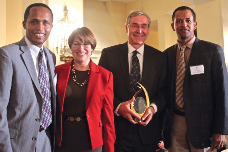 Temali receiving the 2013 E Pluribus Unum Prize