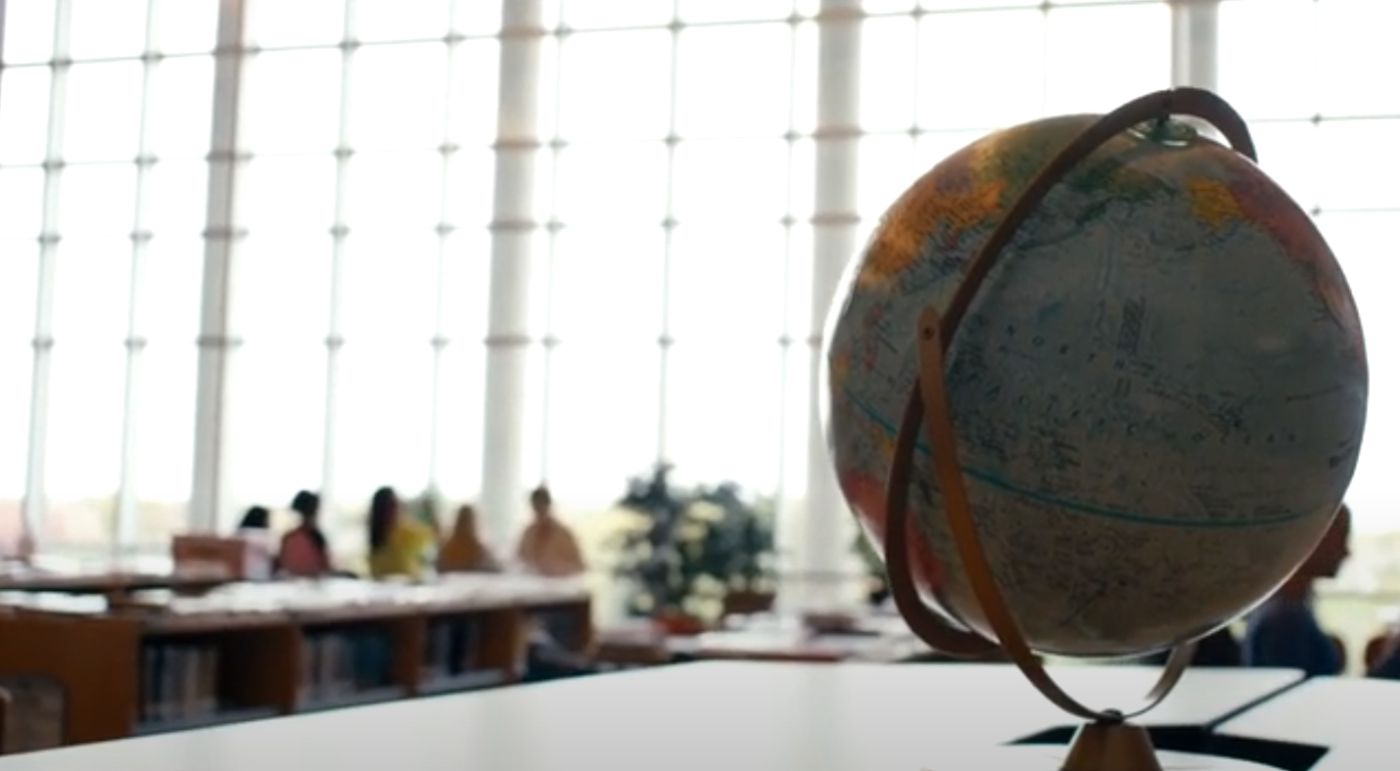 Globe and students at a table