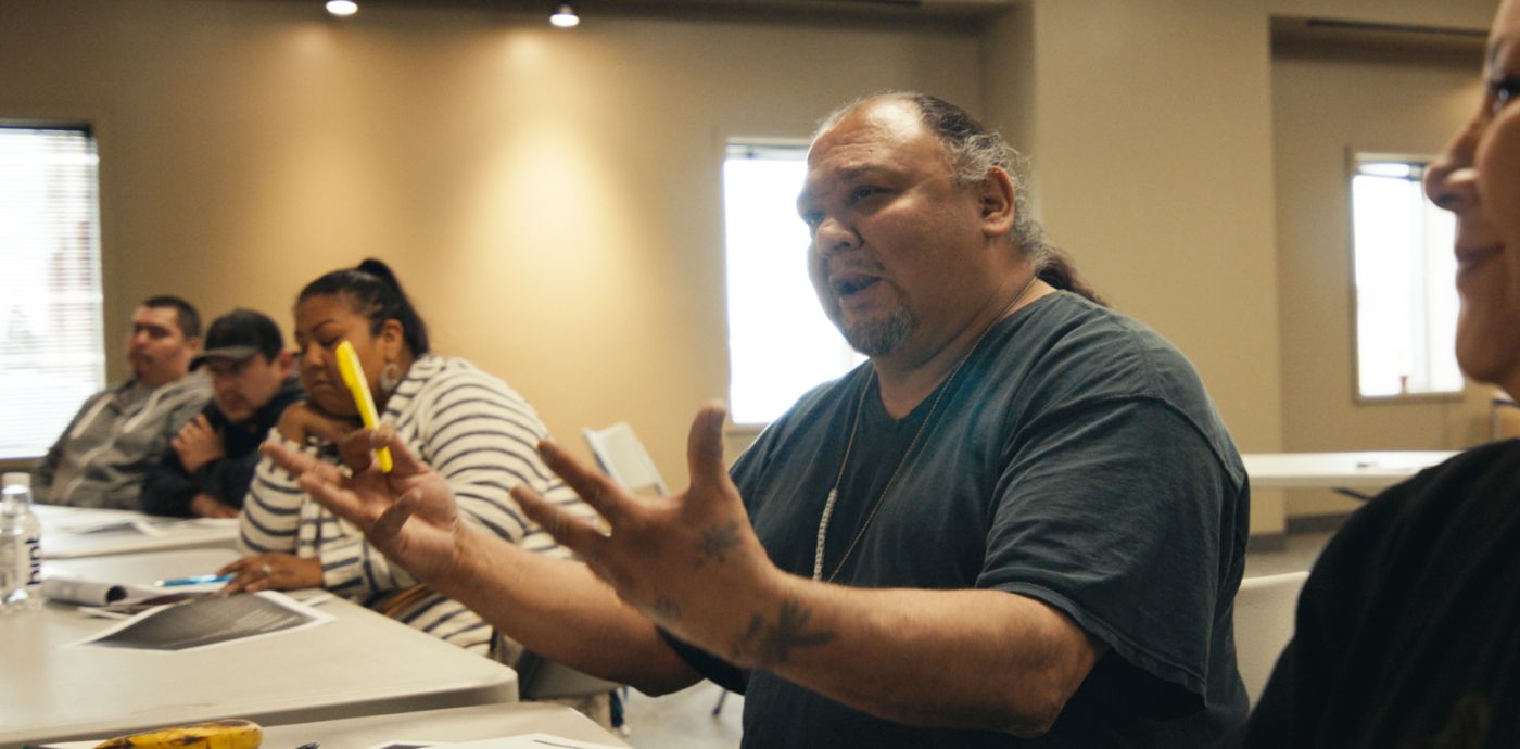 Man speaking with outstretched hands