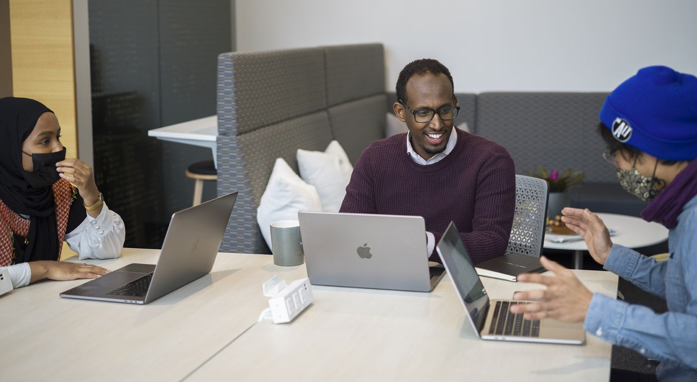 Mukhtar Ibrahim collaborating with colleagues
