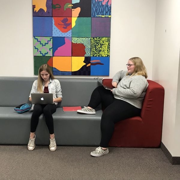 Students work while sitting on colorful couches at Spring Grove School