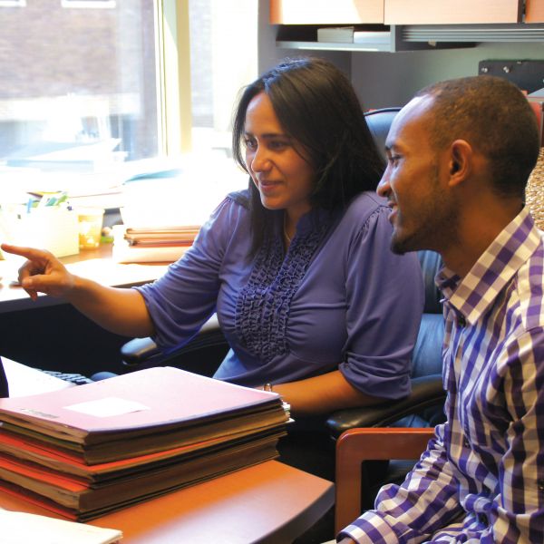NDC Director of Lending Perla Mayo (left) working with a borrower