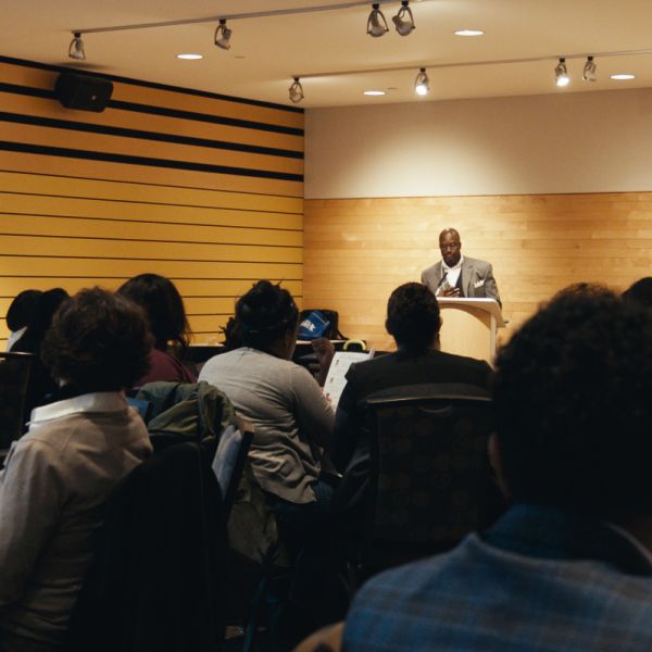 Man presenting to a crowd