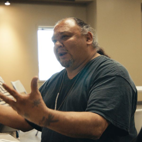 Man speaking with outstretched hands