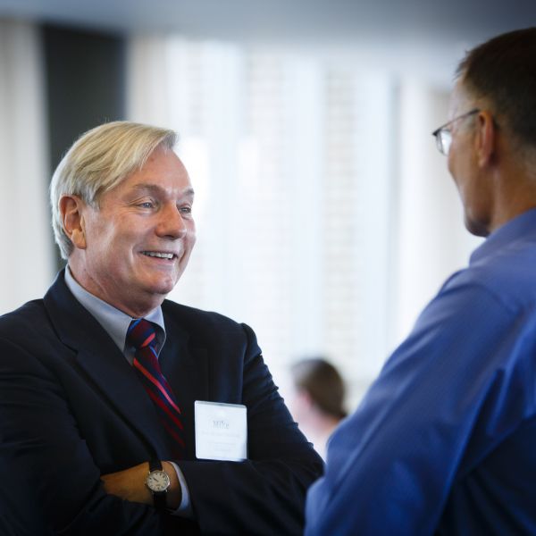 Osterholm speaking with another person