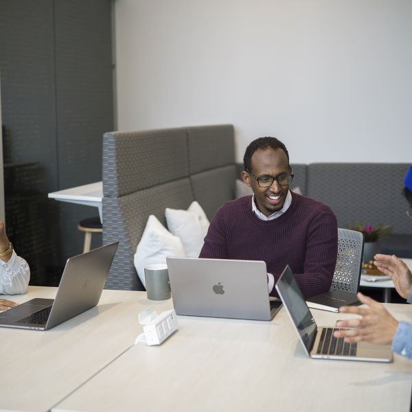 Mukhtar Ibrahim collaborating with colleagues