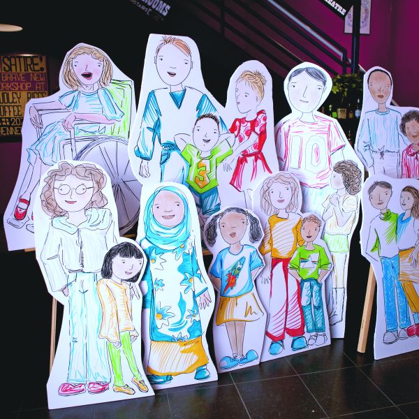 Cut out, life-sized drawings of a group of children