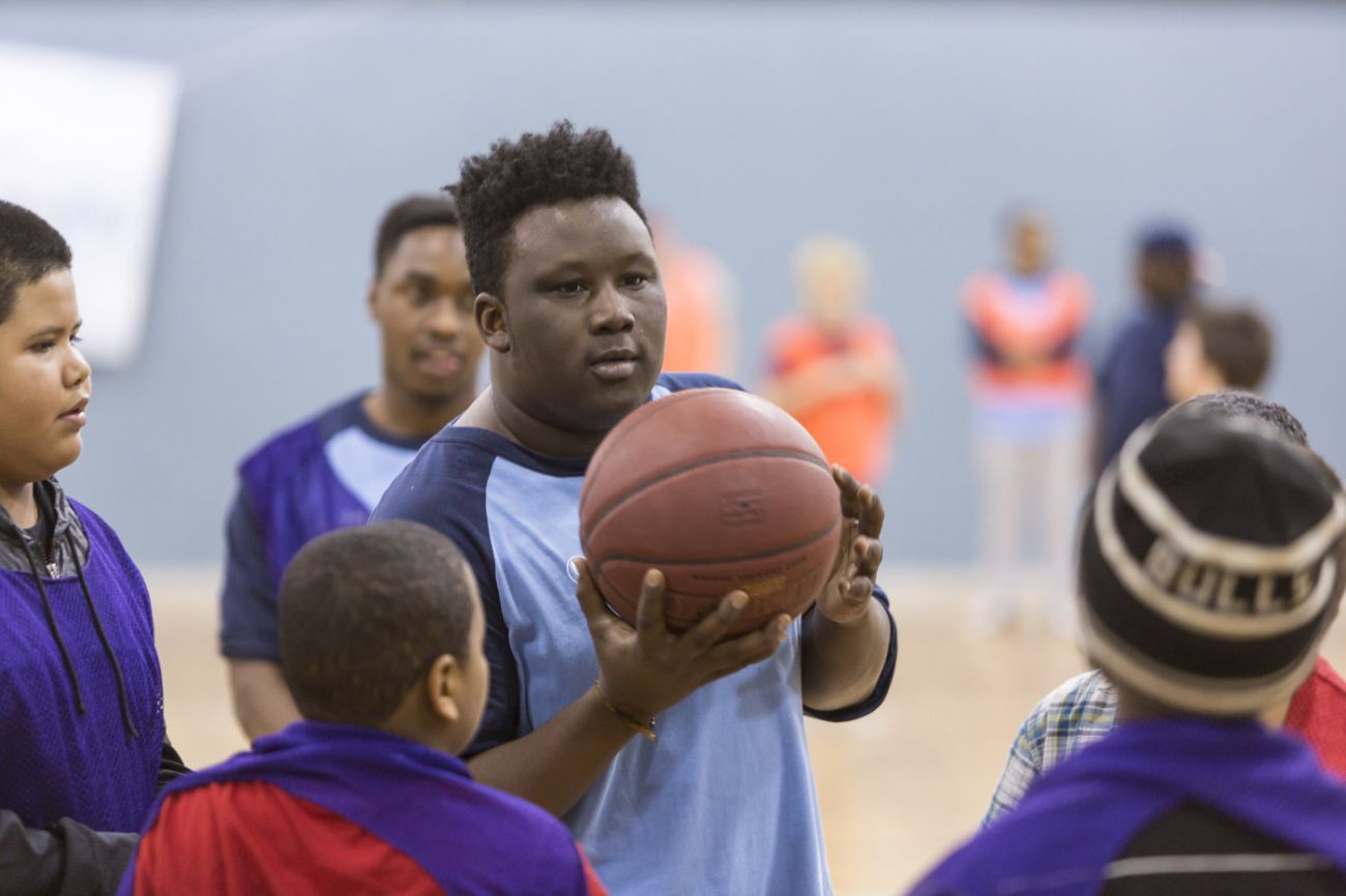 People playing basketball with kids
