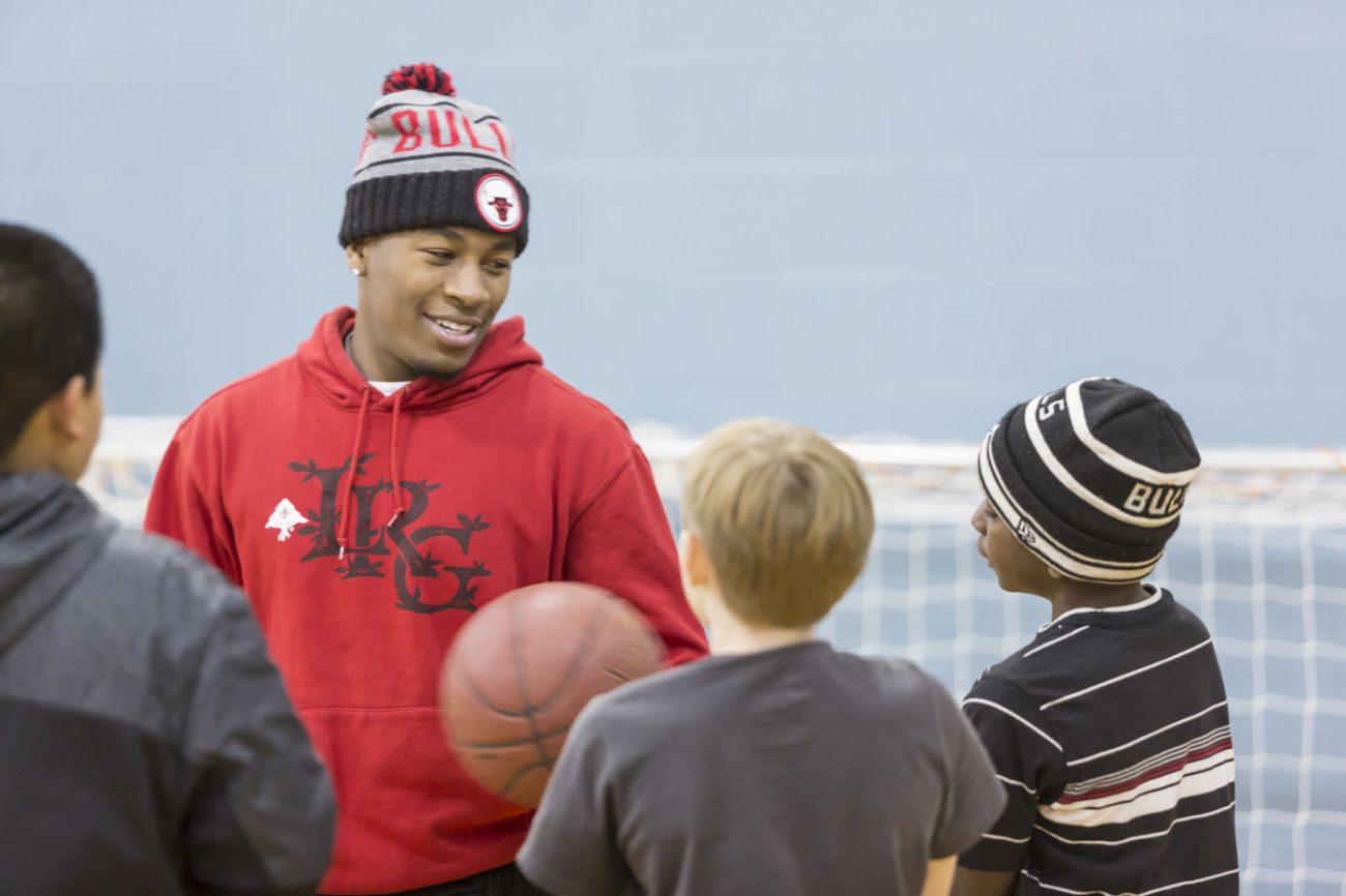 People playing basketball with kids