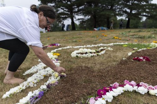 A woman making a buffalo with flowers on the ground of the park.