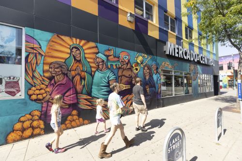 people on sidewalk in front of Mercado 