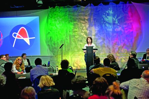 Amelia Franck Meyer speaking on stage at a podium