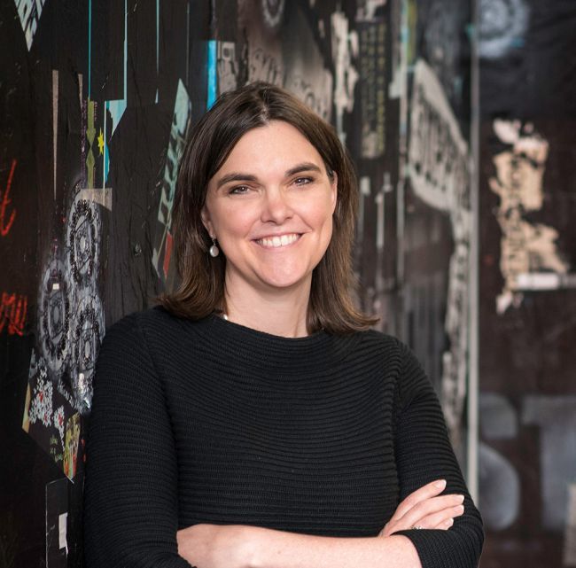 Headshot of Jen Food Reedy with a mural background