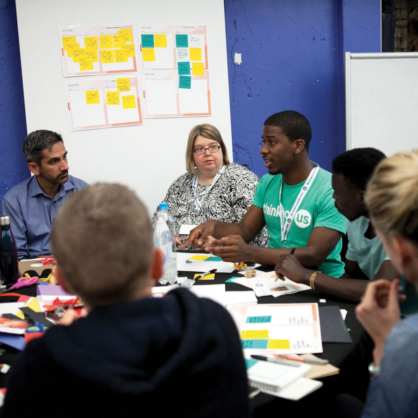 Group of people sitting around a table actively working