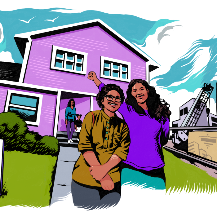 Two people standing in front of a beautiful house and smiling. 